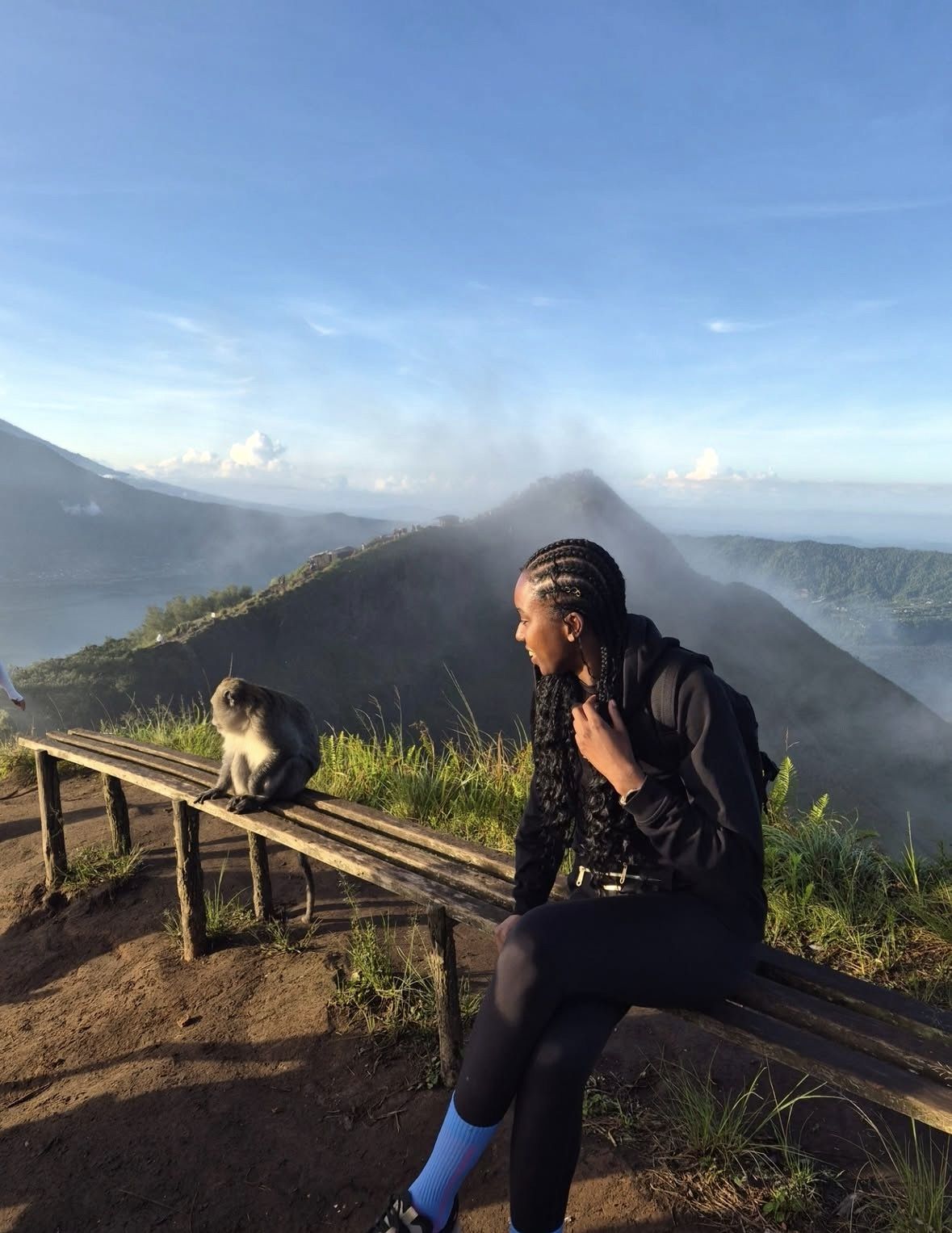 Winding mountain road leading through rice terraces toward the Kintamani caldera rim in Bali